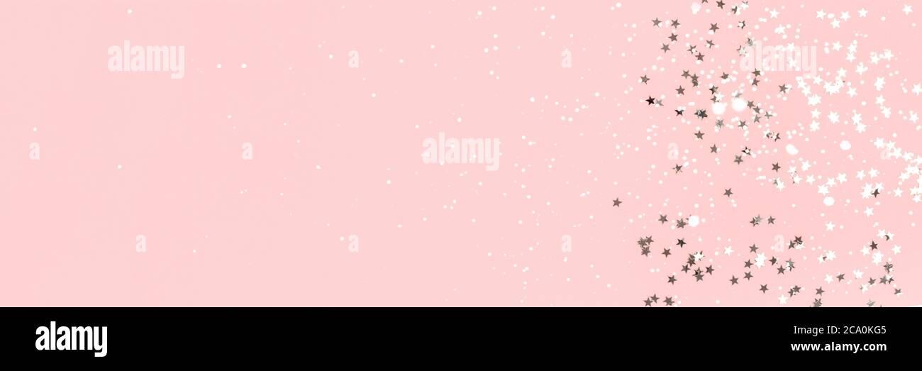 Silver stars confetti on a pink pastel background. Holidays banner with ...