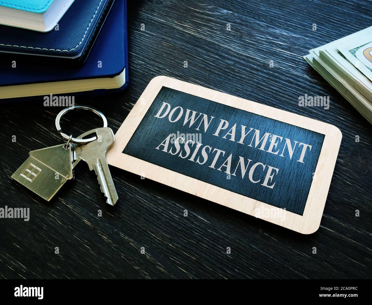 Down payment assistance phrase and house key. Stock Photo