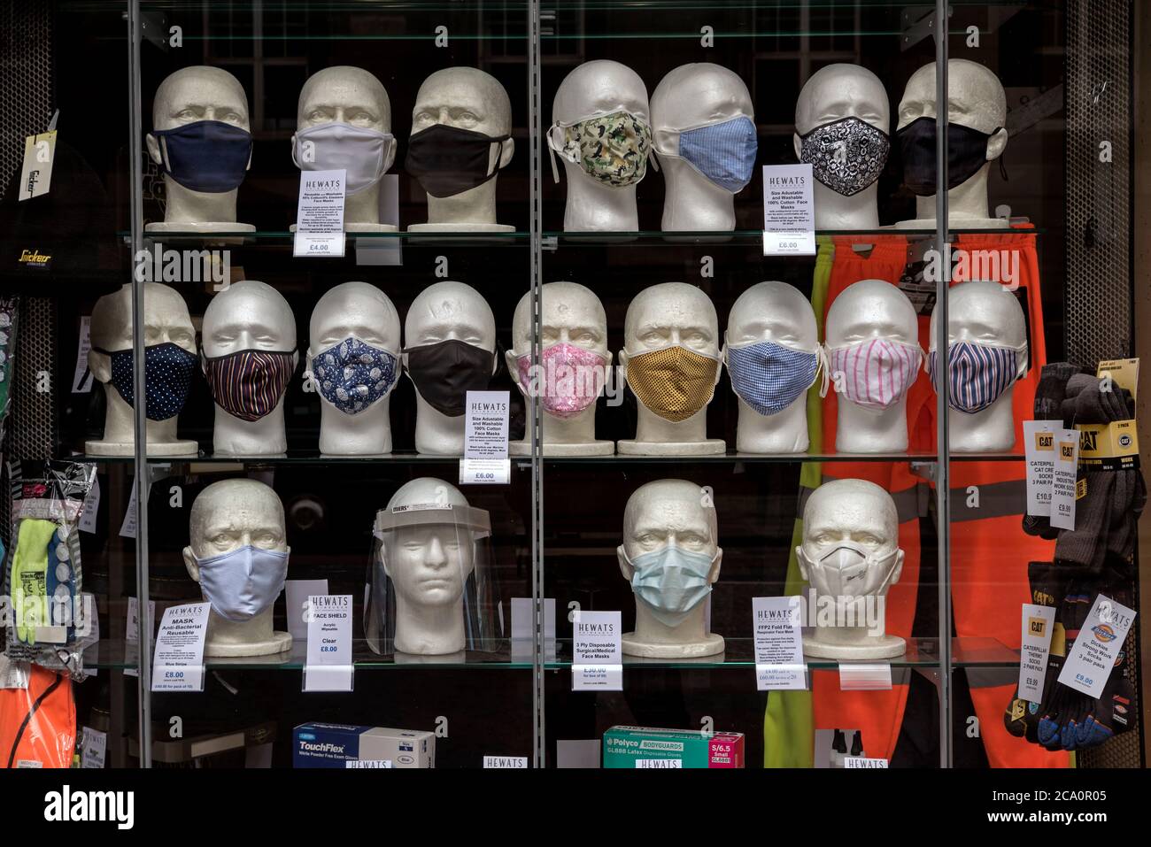 Selection on face masks on display in the window of Hewats in Edinburgh during the covid-19 coronavirus pandemic. Scotland, UK. Stock Photo