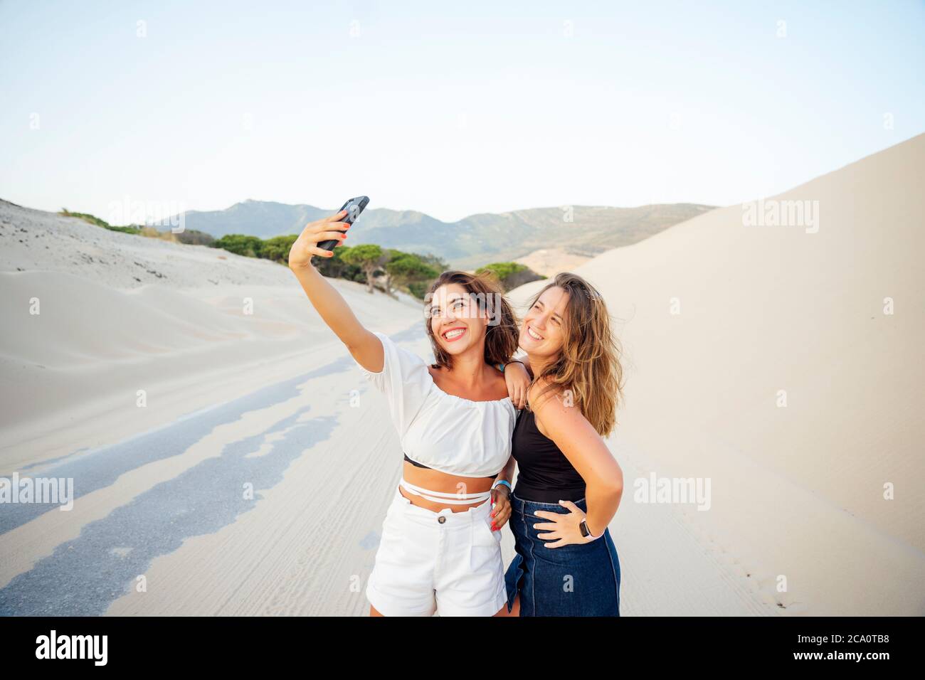Young women with mobile phones are excited and happy Stock Photo