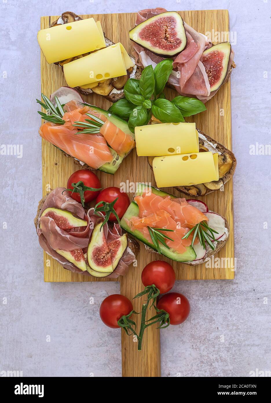 Homemade toast sandwich with salmon, ham, and cheese. Vertical