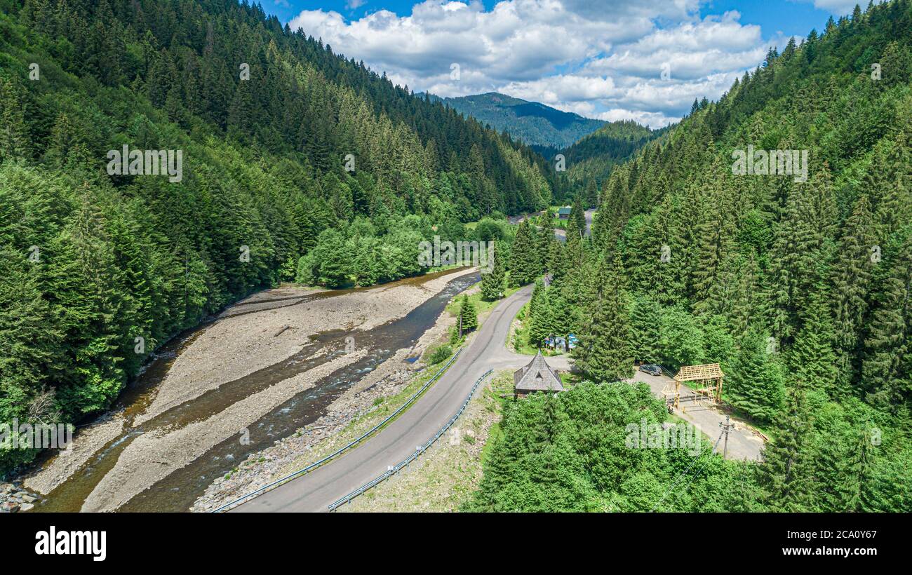 Automobile bridge over the river on the background of the forest in the mountains. Stock Photo