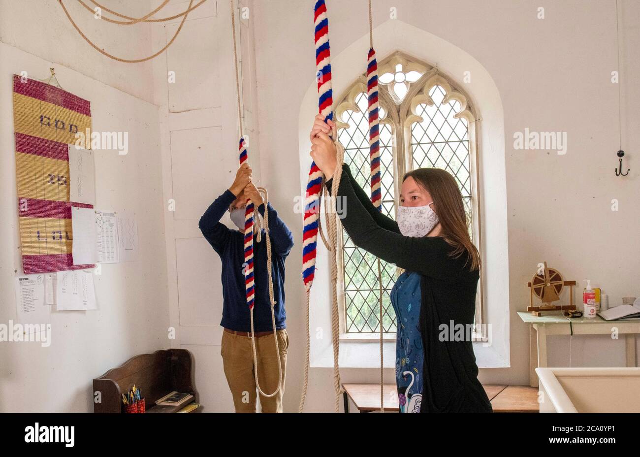 THE world's oldest bell is set to ding dong merrily again at St Peter's Church in West Tytherley. The bell dates back to 1260 and is the oldest in the world hung for full circle ringing. It is in the church tower alongside two other bells dating back to 1399 and 1725 but they have not been heard at St Peter's Church, West Tytherley since the beginning of lockdown Pic Shows Bell ringers Gary Davies 56 and Charlotte Rimmington 28yrs checking the social distancing guidelines to ring the bells prior to Sunday Stock Photo