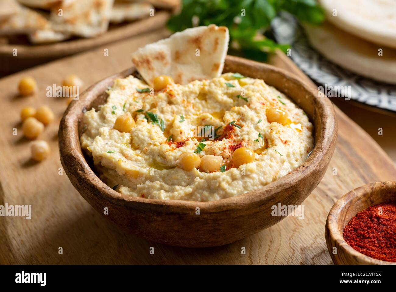 Homemade chickpea hummus bowl with pita chips and smoked paprika. Closeup view, square crop Stock Photo