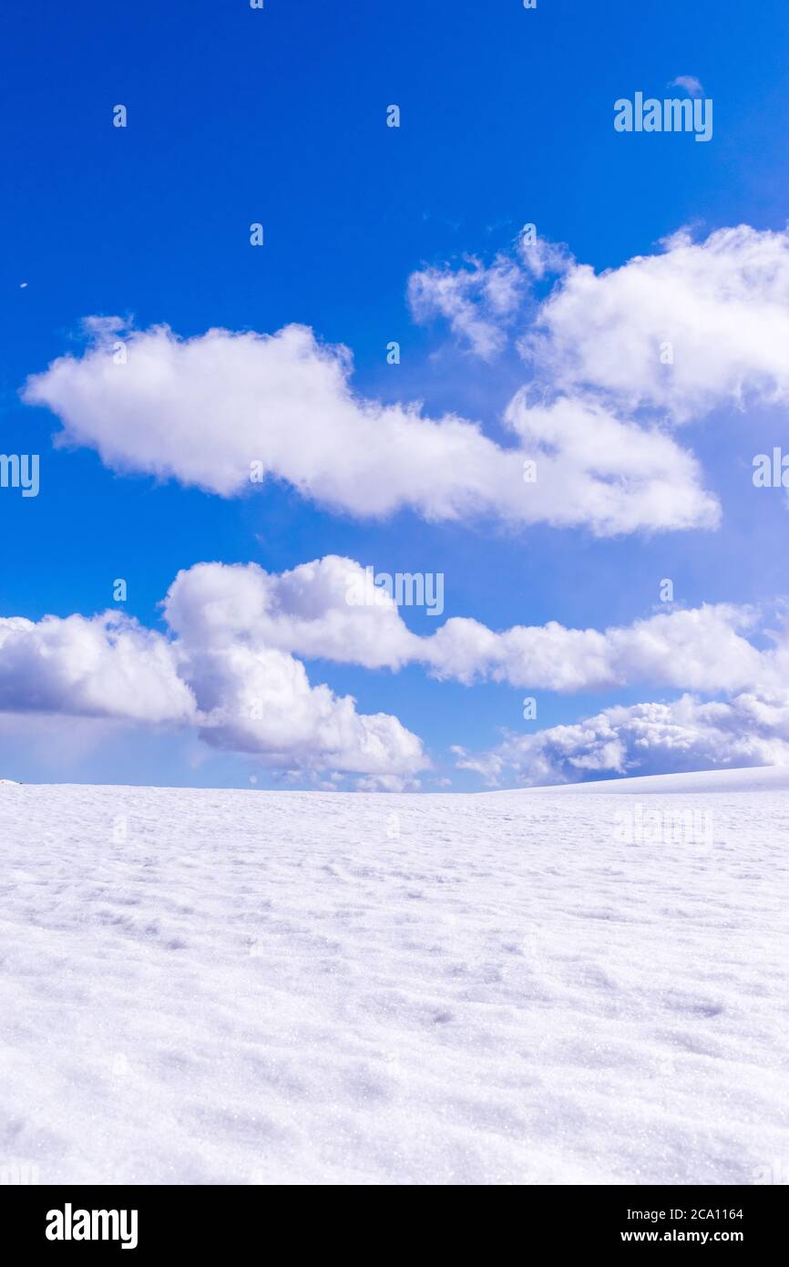 Great plain with snow on a sunny day with nice clouds. Stock Photo