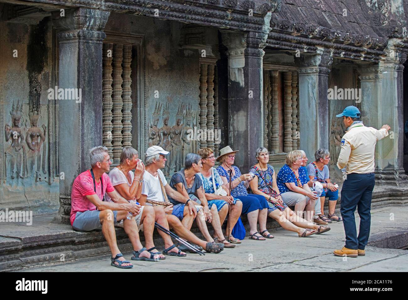 Western elderly tourists with guide visiting the 12th century temple complex Angkor Wat, dedicated to the god Vishnu, Siem Reap, Cambodia, Asia Stock Photo