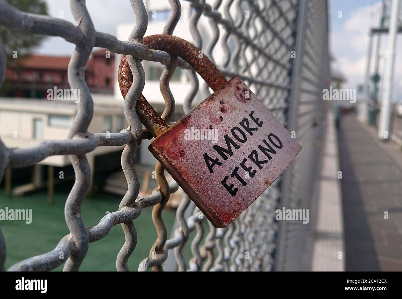 A padlock saying “Eternal Love” (Amore Eterno - in Italian). Locked to the fence at Venice, Italy. Stock Photo