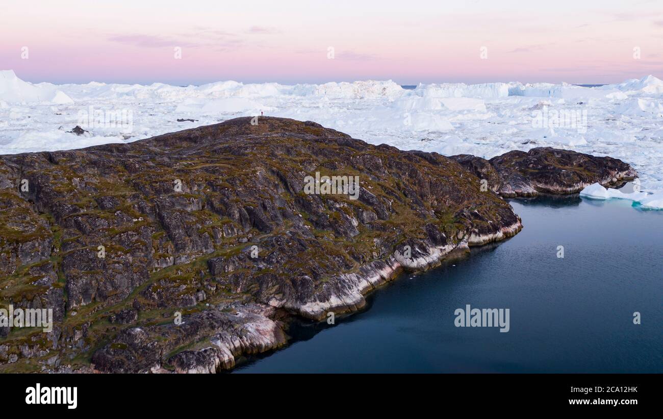 Arctic landscape nature with icebergs and ice in Greenland icefjord. Aerial drone image of ice and iceberg. Ilulissat Icefjord with icebergs from Stock Photo