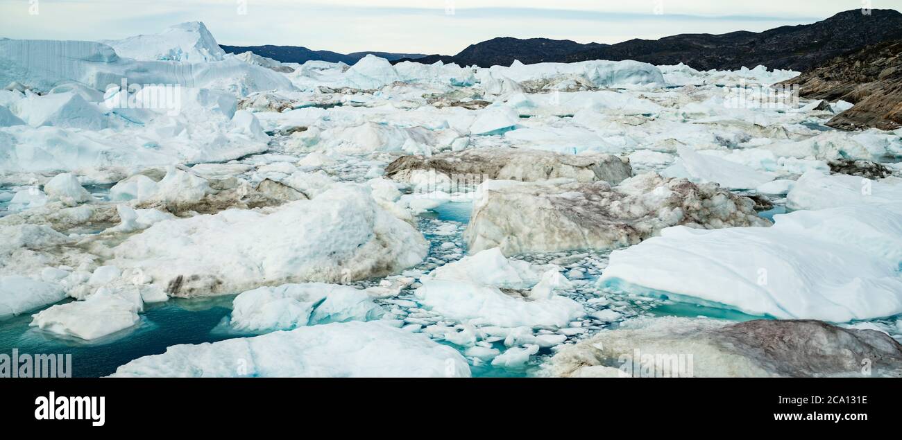 Climate Change and Global Warming - Icebergs and from melting glacier in icefjord in Ilulissat, Greenland. Panoramic banner photo of arctic nature ice Stock Photo