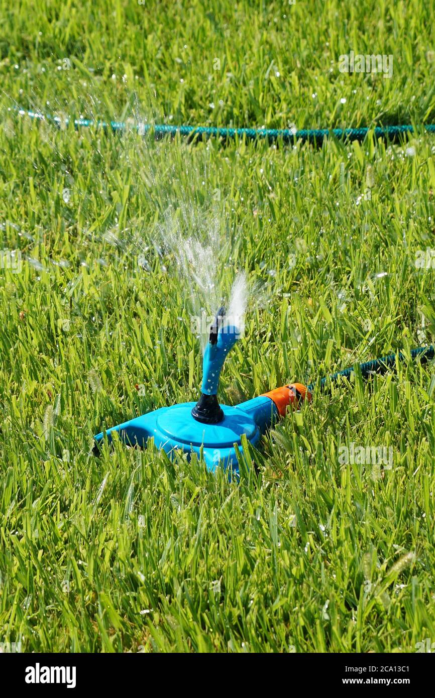 automatic watering the lawn in the park closeup Stock Photo Alamy