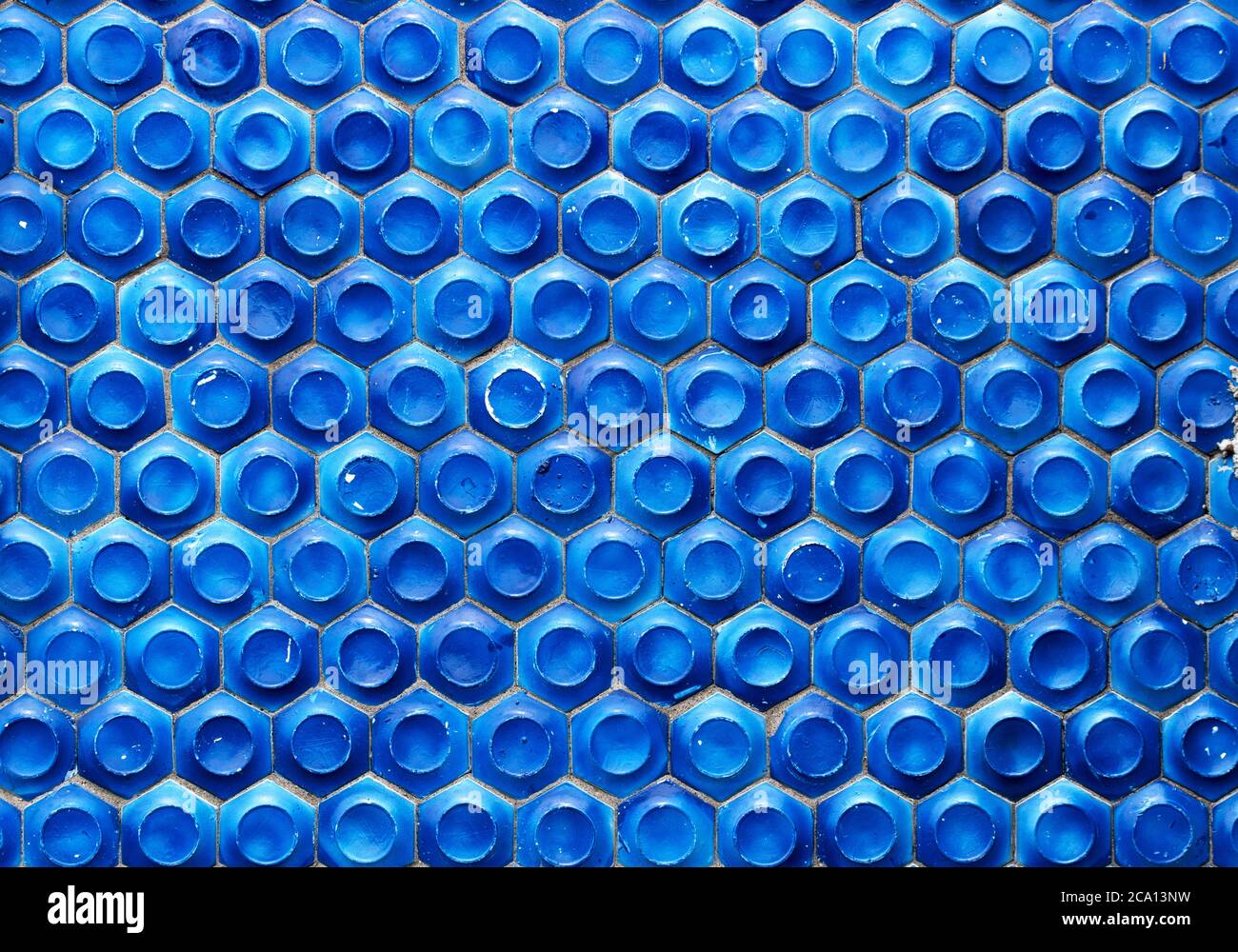 Mosaic of the Soviet period in the form of honeycombs on a concrete wall. Stock Photo