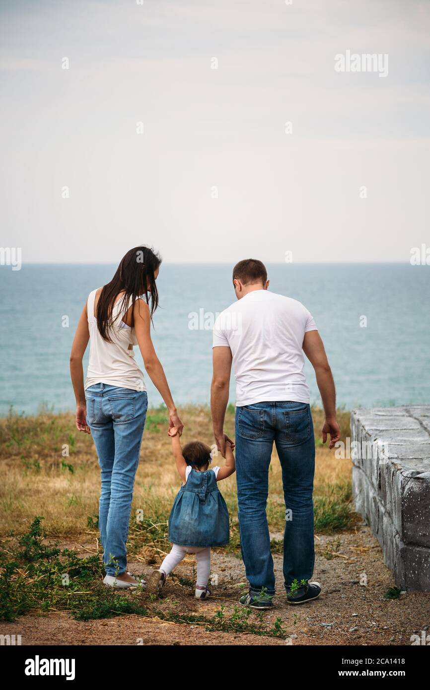 family in white t-shirts and blue jeans 