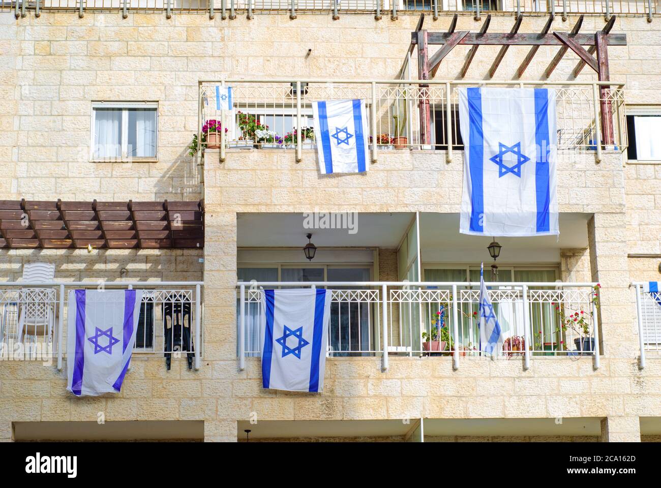 Front side of typical israeli house with israel flags on window. Givat Shaul neighborhood in Jerusalem, Israel. Stock Photo