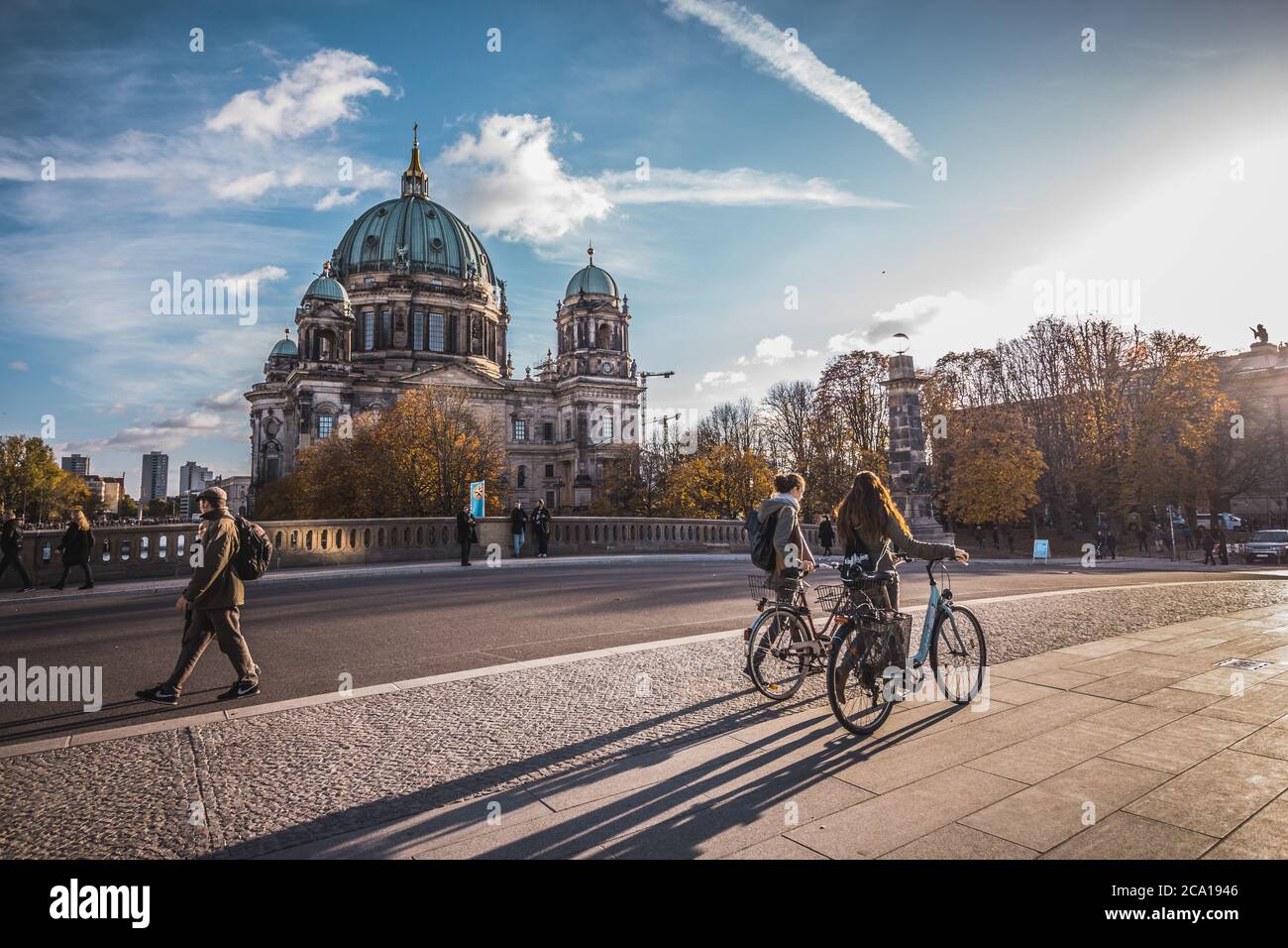 People walking in the Friedrichsbrücke (Friedrichs bridge) over Spree river and The Berlin Cathedral (Berliner Dom) in the background in Berlin Stock Photo