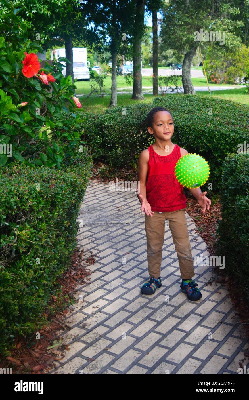 Black young boy playing outside Stock Photo