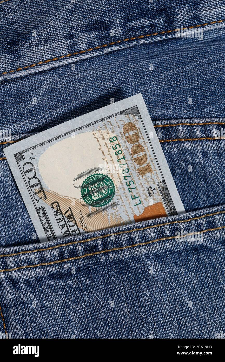one hundred dollar in jeans pocket Stock Photo