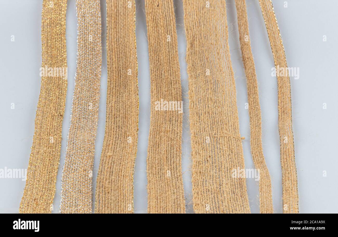 Colored jute ribbon rolls isolated on white background. Natural Braided