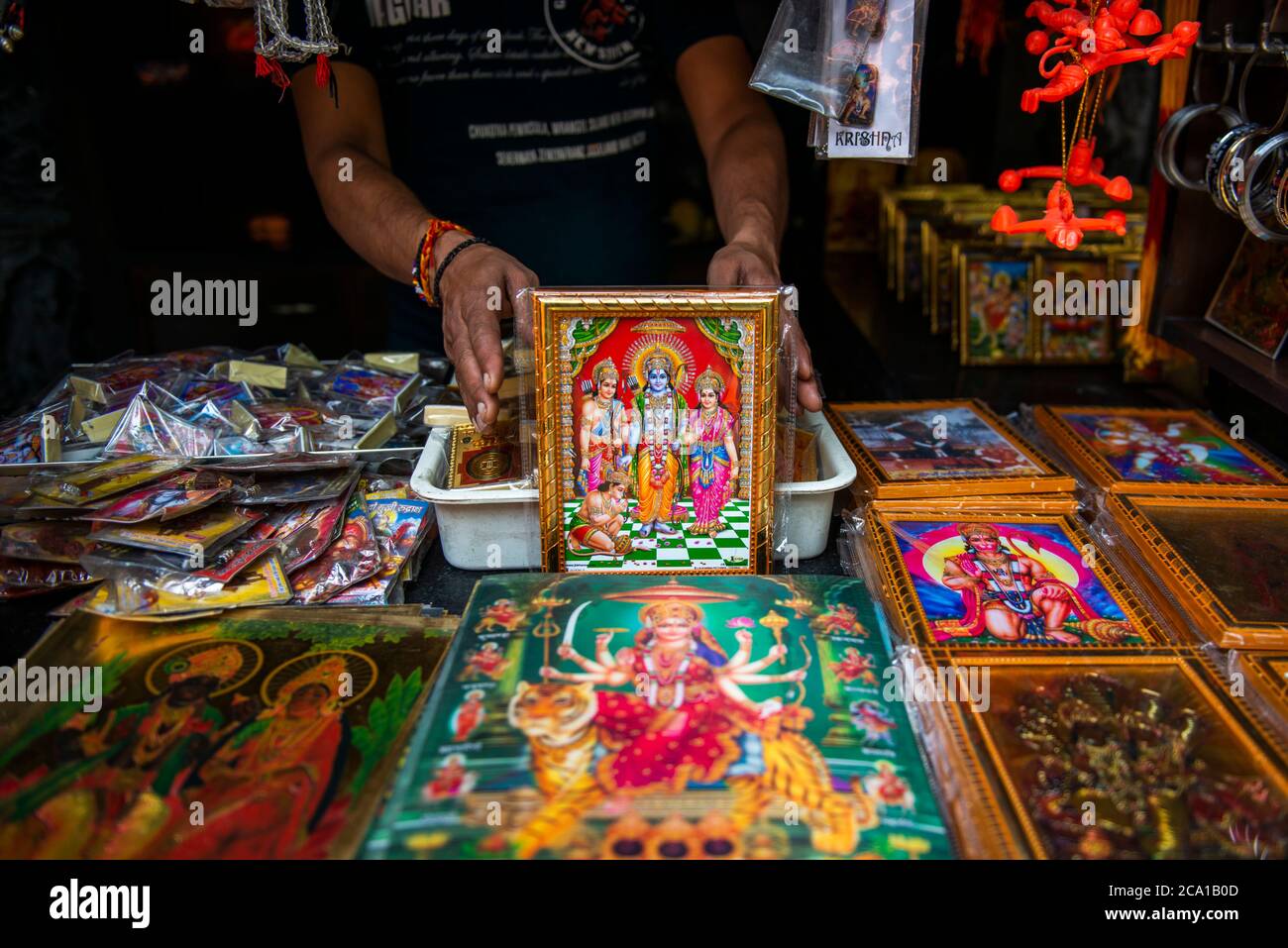 A shopkeeper is seen showing a variety of colourful frames of Lord Rama  .Lord Rama is one of the most adored god and hero of the epic ' Ramayana '  He is