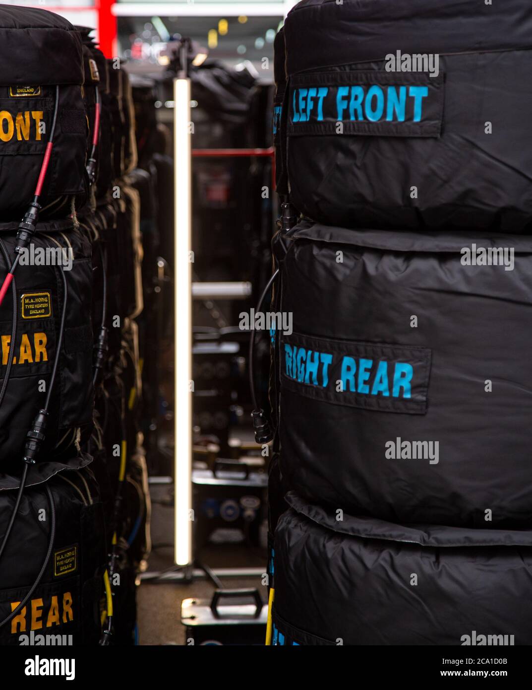 Stacked Tyres in tyre warmers in an F1 pit garage at the Red Bull Ring, Austria Stock Photo
