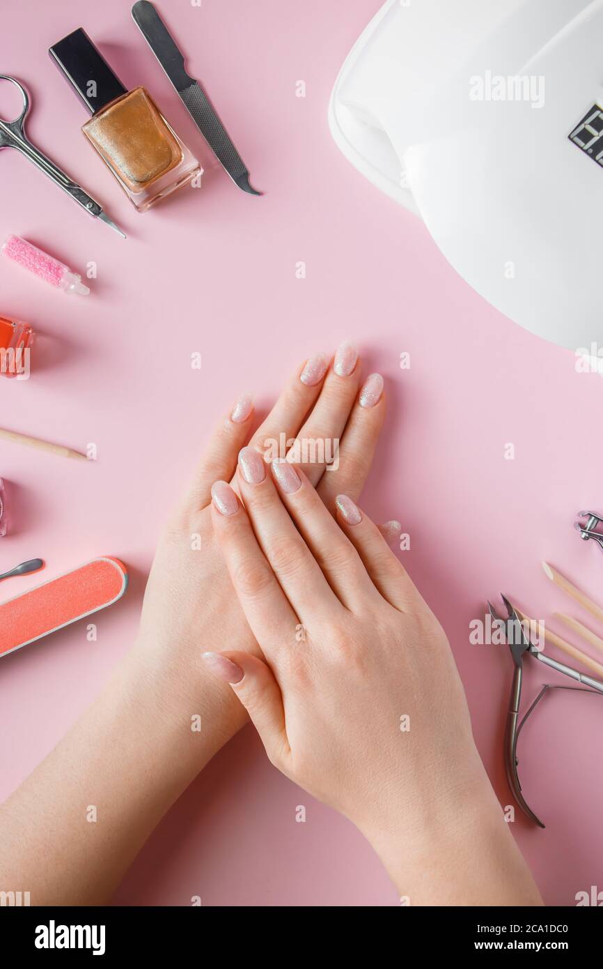 Spa procedure for nail care in a beauty salon. Female hands and tools