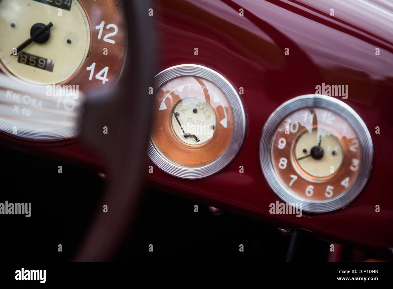Close up shot of a vintage car's oil pressure gauge an analogue clock
