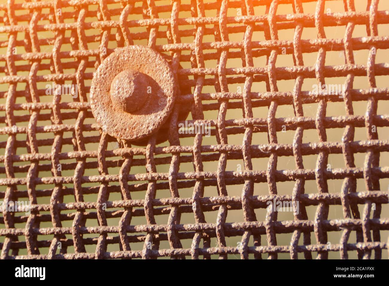 Rusty grid and large metal bolt Stock Photo