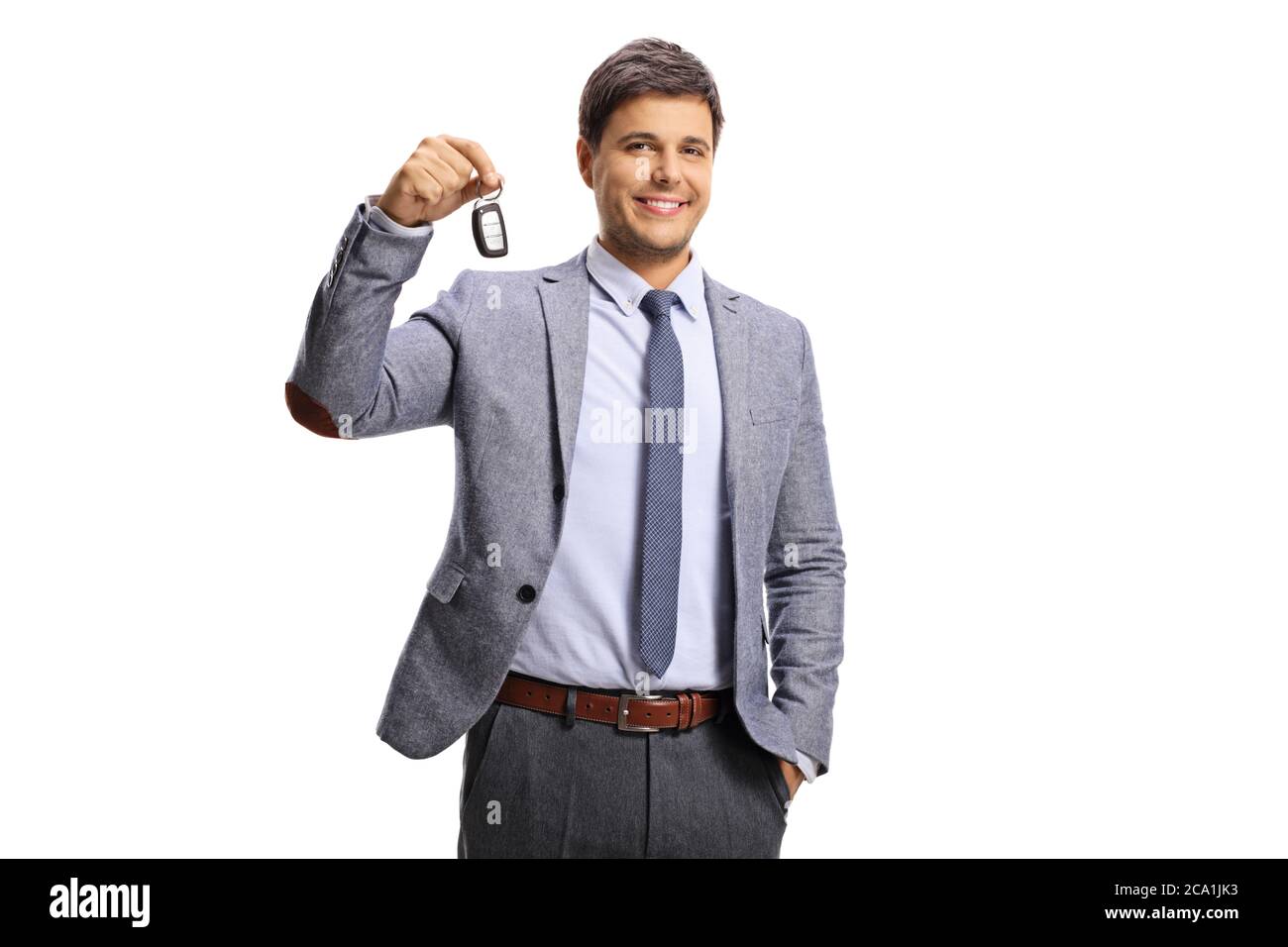 Guy in formal clothing holding a car key isolated on white background ...