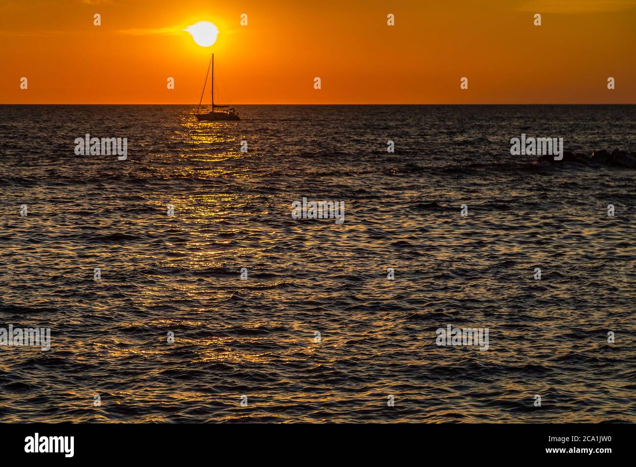 sun shining on sea waves at sunset Stock Photo - Alamy