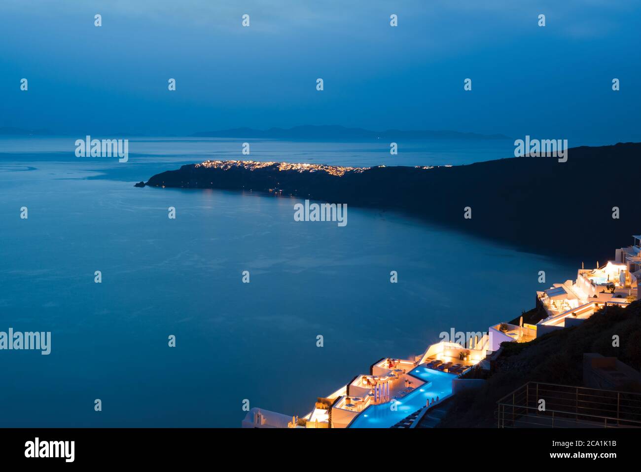 Night view of village on cape in the sea. Oya, Greece Stock Photo