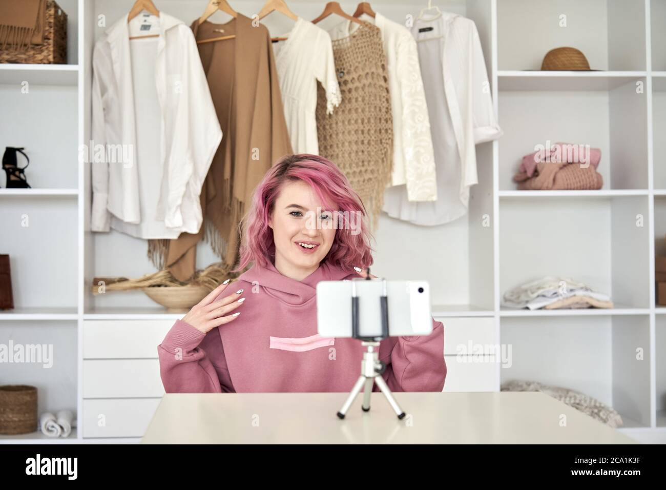Happy hipster gen z teen girl fashion blogger pink hair recording video