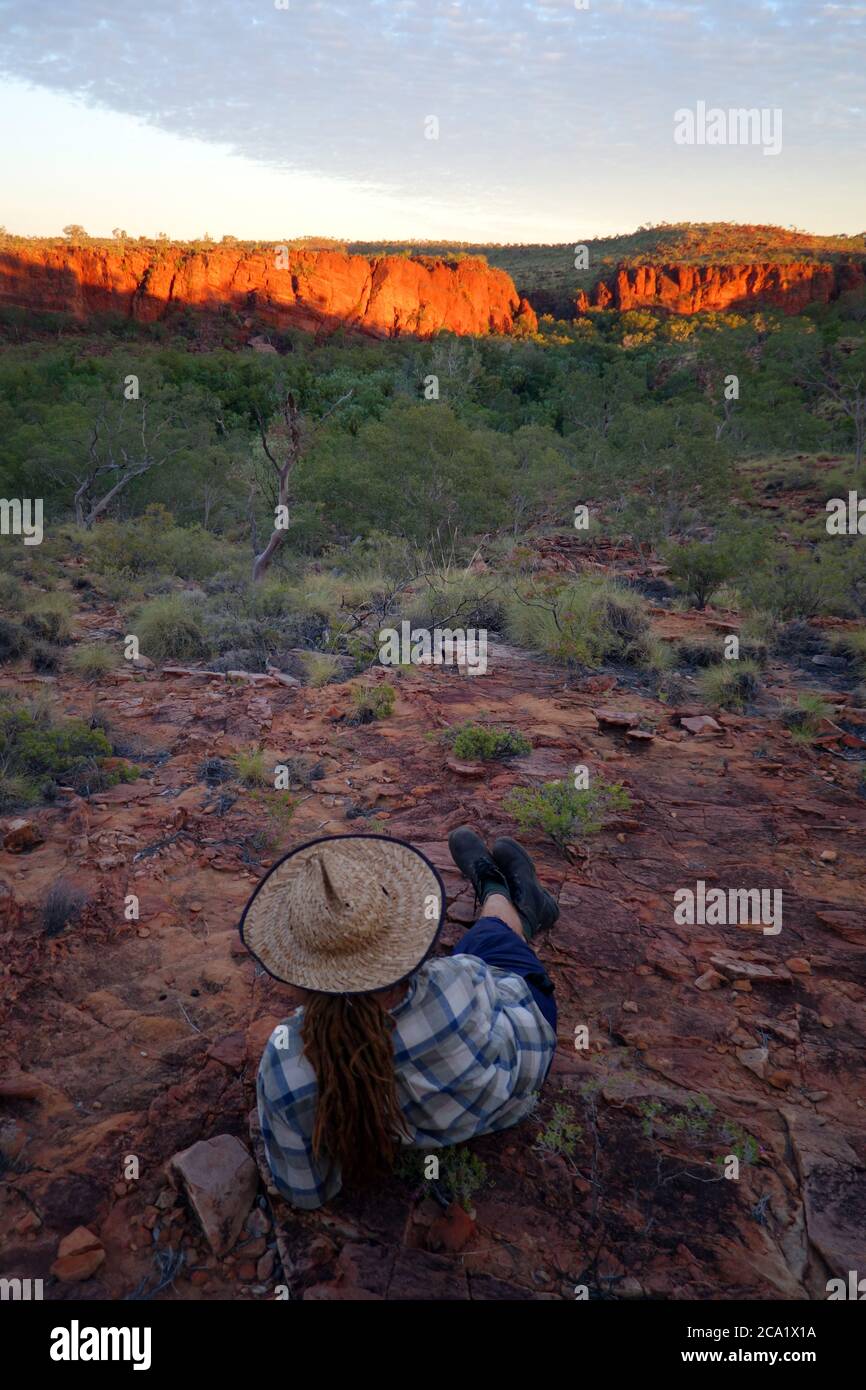 Man watching dawn over Boodjamulla (Lawn Hill) National Park, from the Constance Range, outback Queensland, Australia. No MR Stock Photo