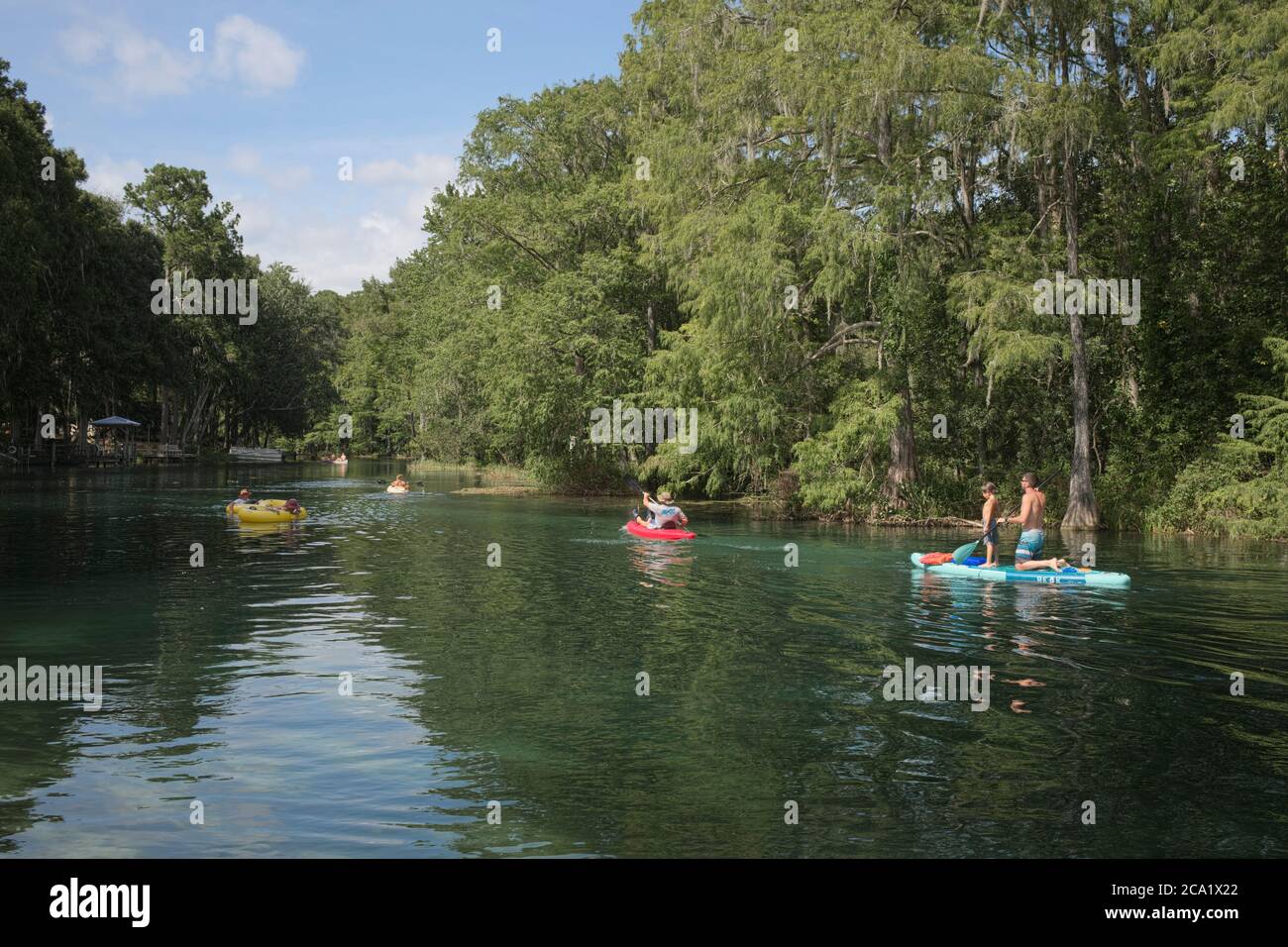 People enjoying the clear spring fed Rainbow River in Dunnellon, Florida. A popular North Central Florida travel destination. A beautiful scenic water Stock Photo