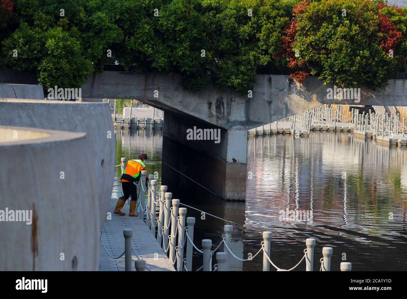 Jakarta / Indonesia - July 25, 2020. PPSU officers who are cleaning up trash in the river area of the old city of Jakarta Stock Photo