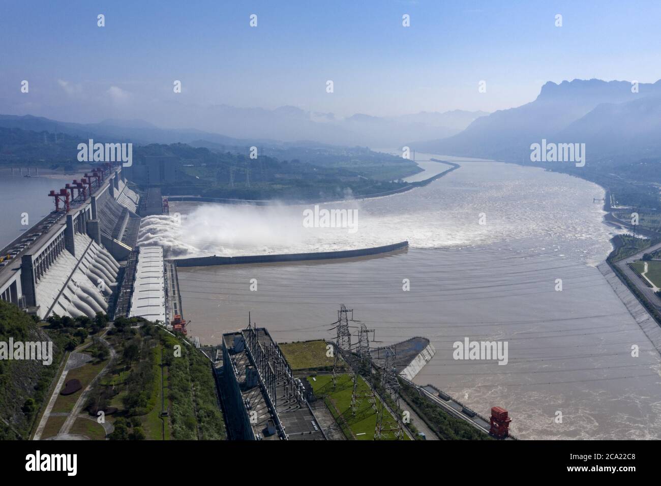 Beijing, China. 2nd Aug, 2020. Aerial photo taken on Aug. 2, 2020 shows water gushing out from the Three Gorges Dam in central China's Hubei Province. According to the Changjiang Water Resources Commission of the Ministry of Water Resources, reservoirs along the upper and middle reaches of Yangtze River, including the Three Gorges Dam and the Gezhou Dam, have held back over 30 billion cubic meters of floodwater since July this year. Credit: Du Huaju/Xinhua/Alamy Live News Stock Photo