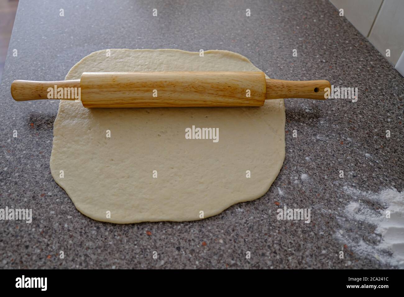 Rolling pin with dough to prepare Nigerian Chin Chin Stock Photo Alamy