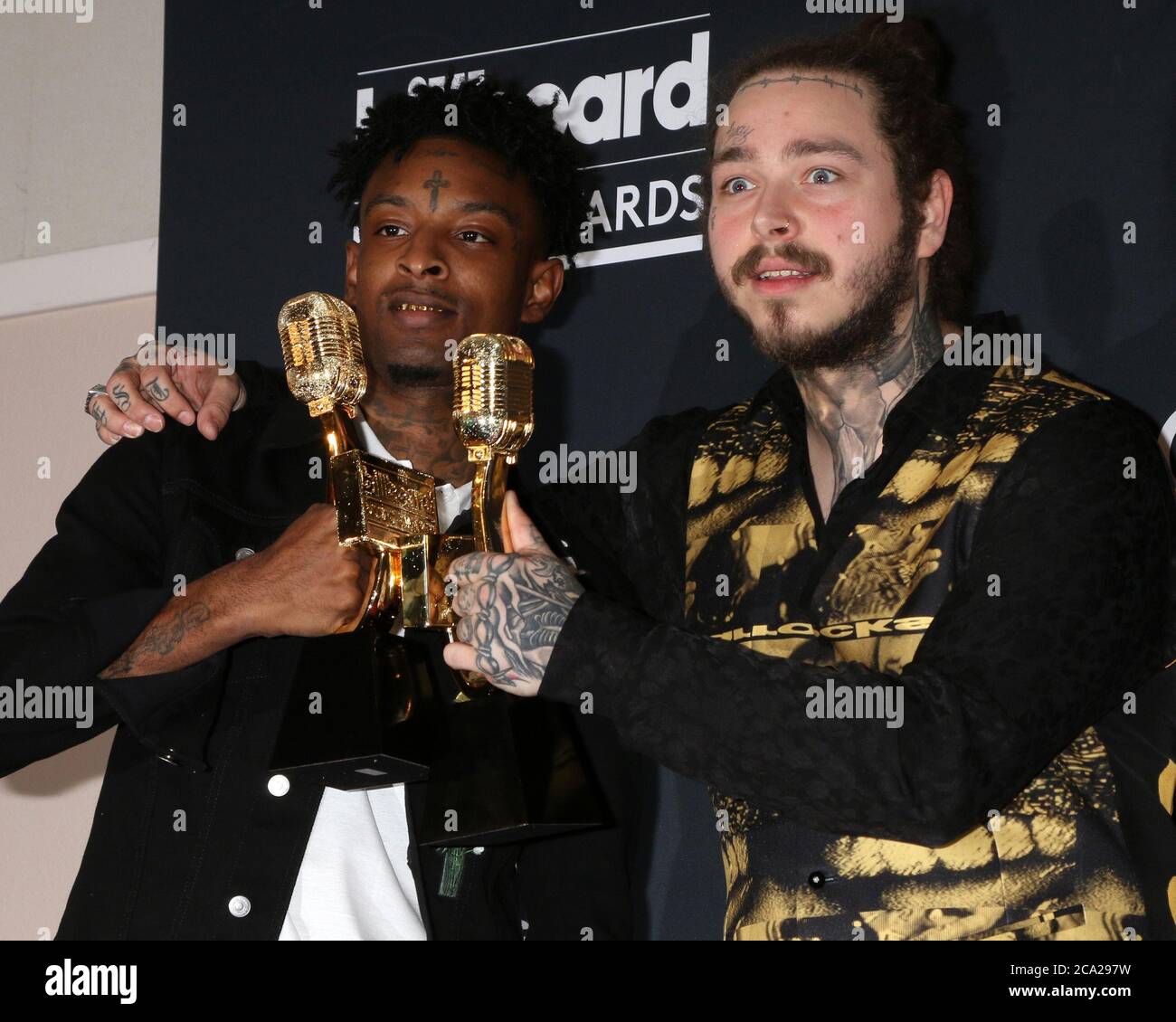 Recording artists 21 Savage (L) and Post Malone appear backstage after  winning the top Rap Song award for 'Rockstar,'' during the 2018 Billboard  Music Awards at MGM Grand Garden Arena on May