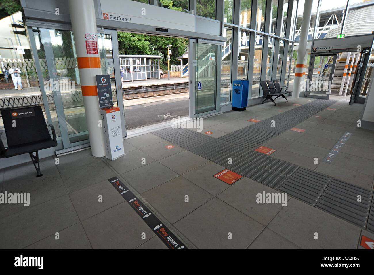 A hand sanitiser station and distancing measures in the new railway station building at Kidderminster, Worcestershire. Opened on 7th June 2020 Stock Photo
