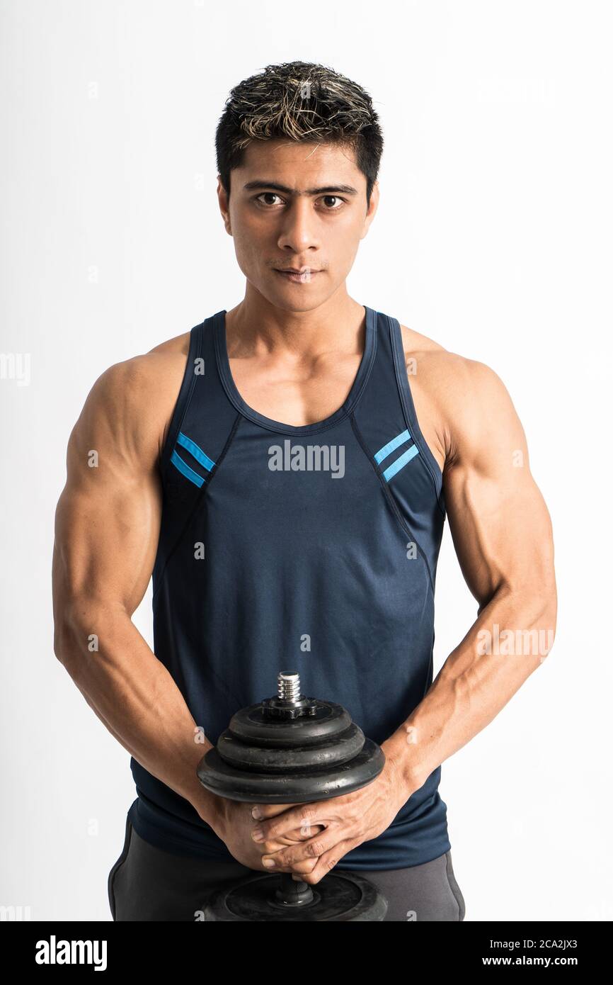 young man wearing gym clothes lift the dumbbell with both hands looking