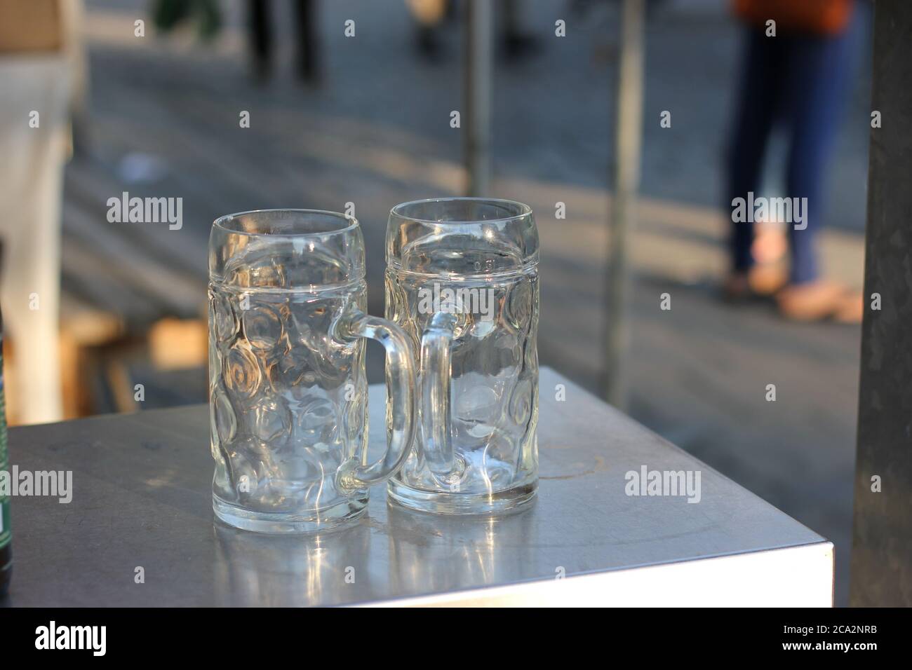 Empty beer mug on metal beer garden table. Stock Photo