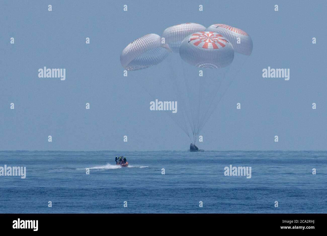 GULF OF MEXICO, USA - 02 August 2020 - The SpaceX Crew Dragon Endeavour spacecraft splashdown with NASA astronauts Robert Behnken and Douglas Hurley o Stock Photo