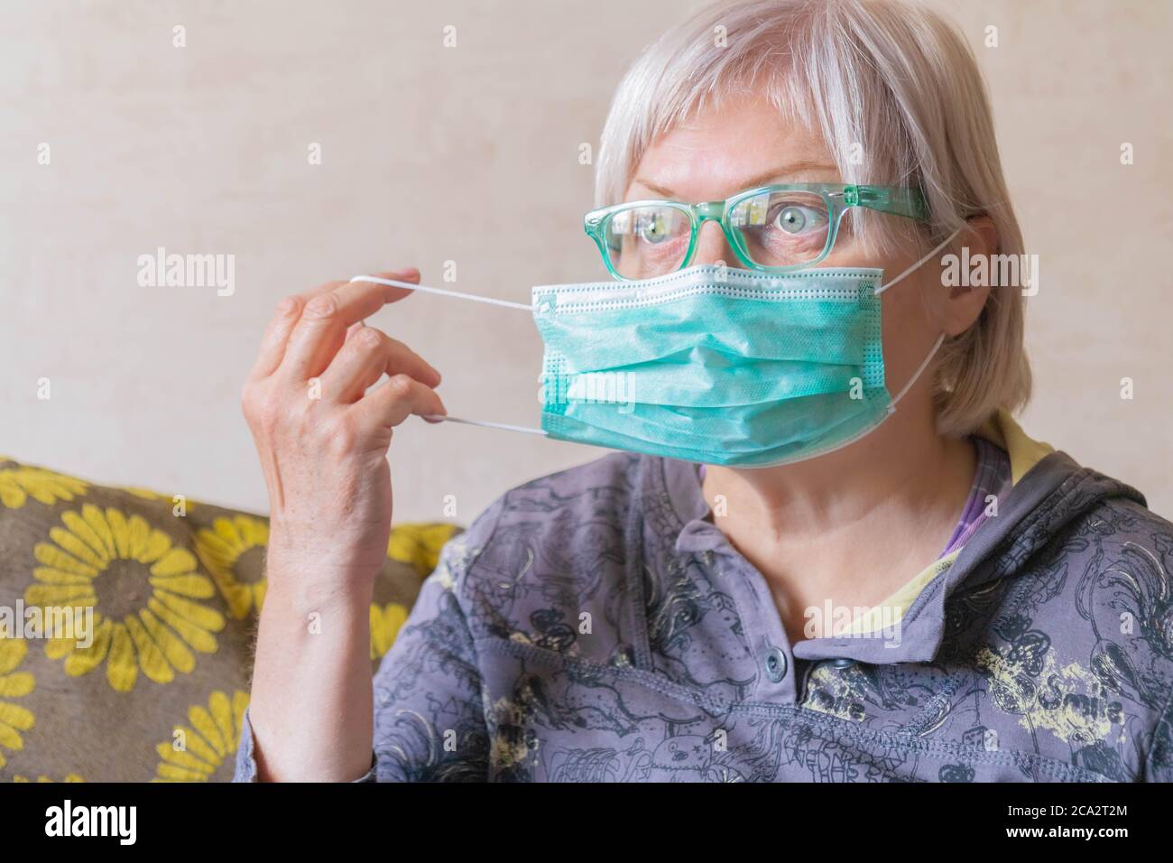 Woman putting on facemask hi-res stock photography and images - Alamy