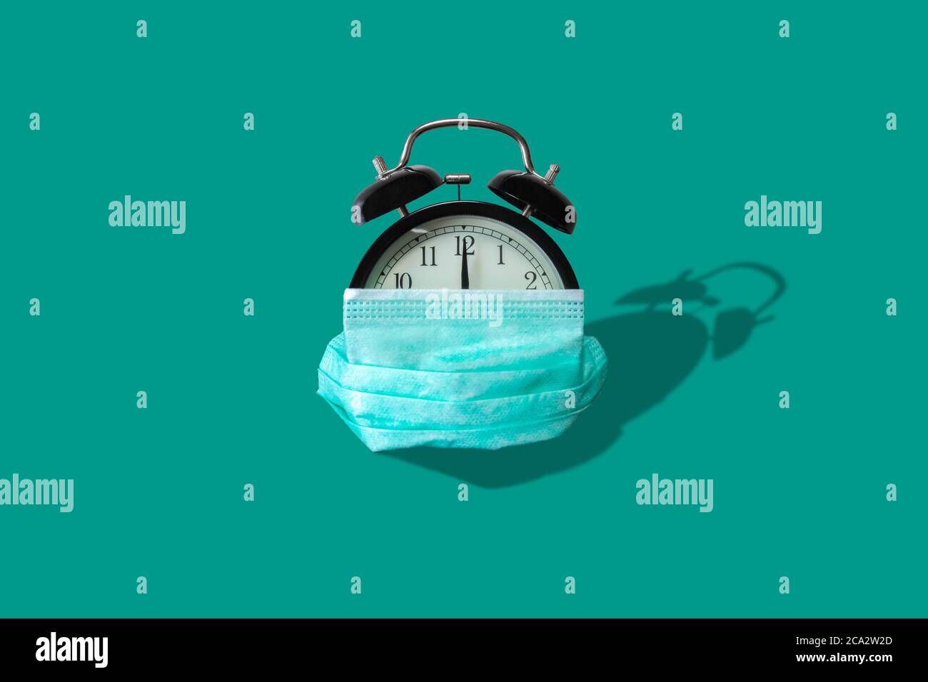Alarm clock with protective mask on isolated background. Disposable ...