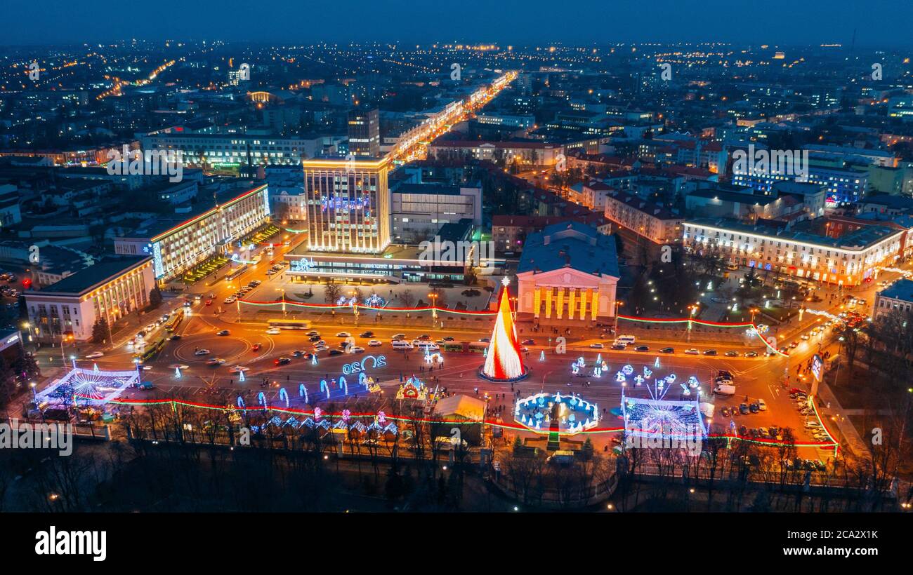 Gomel, Belarus. Main Christmas Tree And Festive Illumination On Lenin Square In Homel. New Year Celebration In Belarus. Aerial Night View. Stock Photo