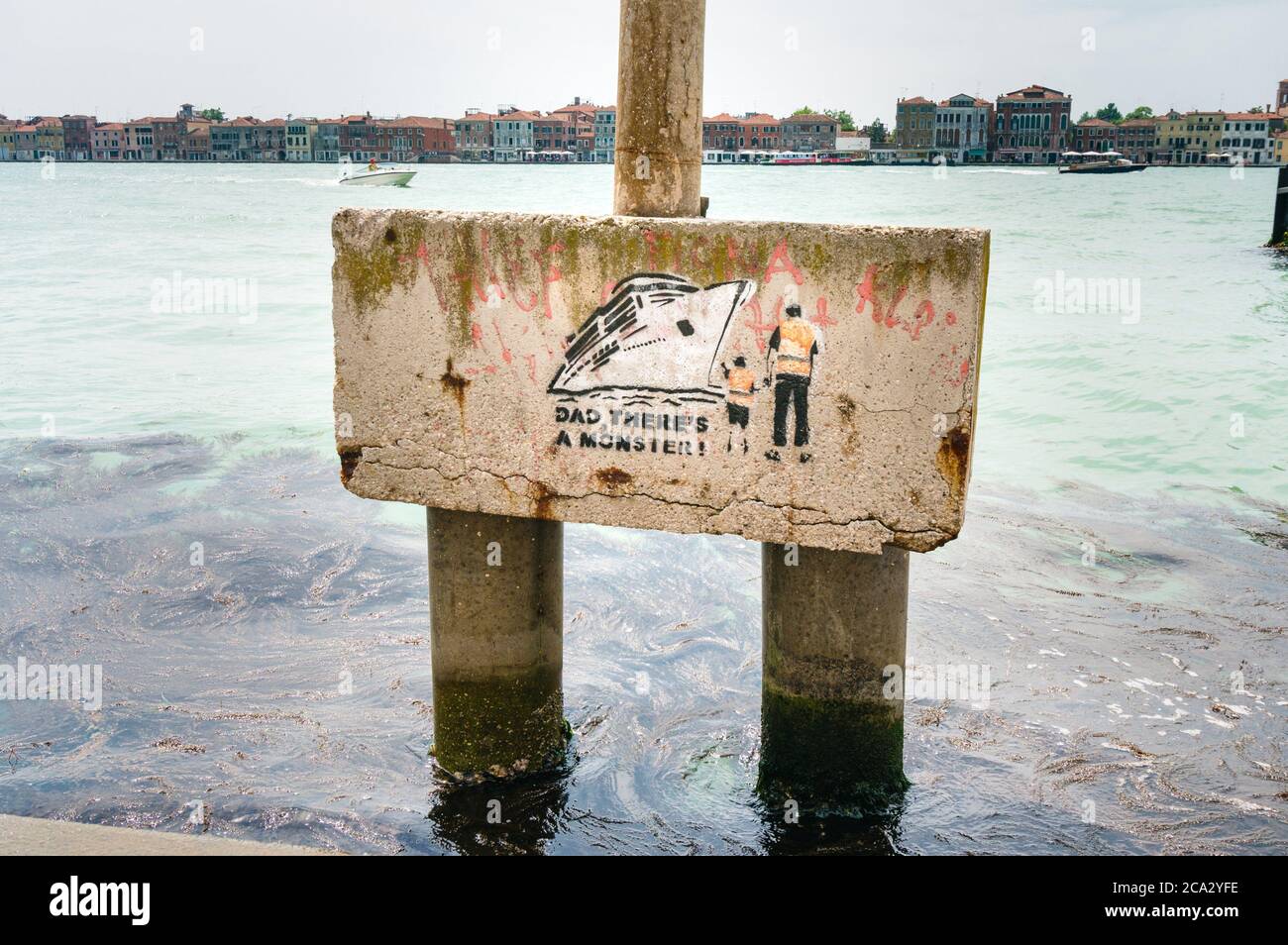Venice, Italy - May 28th 2018. Graffiti artwork denouncing mass tourism, impact environmental destruction, citizen everyday life, hustle, economy. Stock Photo