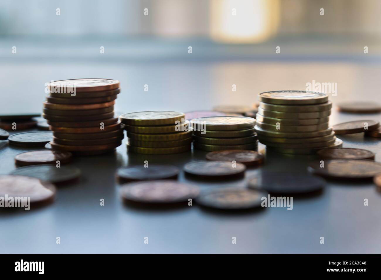 Euro and Europe Coins stacks,diferent sizes and colors.Saving money concept,business and banking..Blurred background Stock Photo