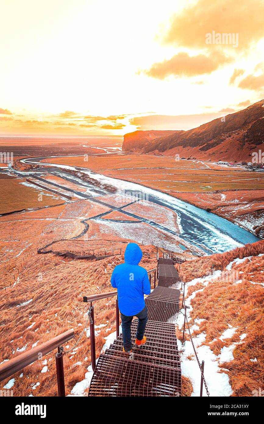 departure man runs towards the freedom of the sun in the icelandic mountain landscape whit snow and sunset. Stock Photo