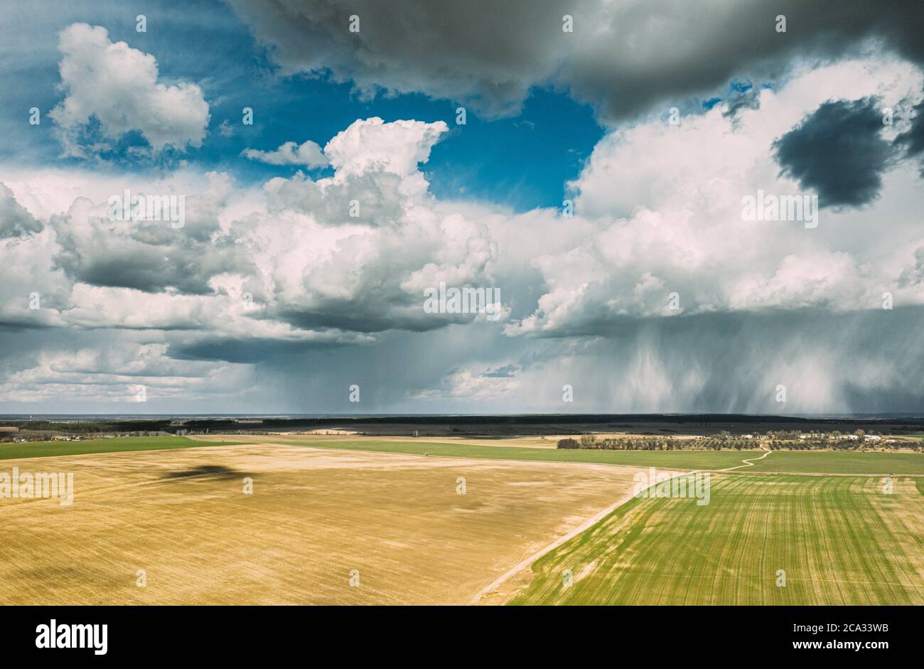 Aerial View. Amazing Natural Dramatic Sky With Rain Clouds Above Countryside Rural Field Landscape In Spring Summer Cloudy Day. Scenic Sky With Stock Photo