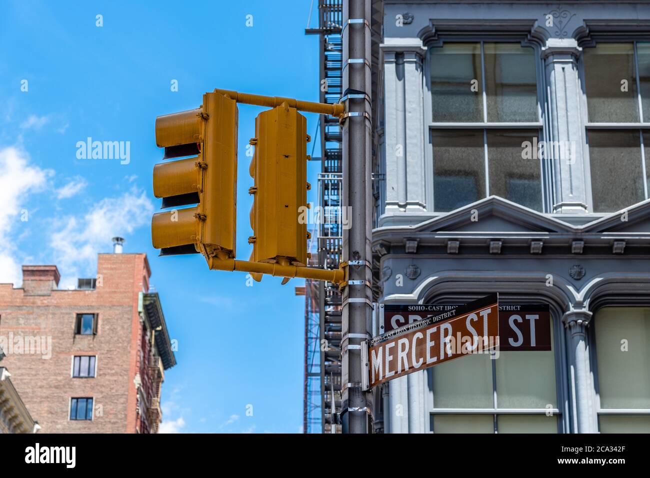 Traffic light and street name sign in Mercer Street in Soho Cast Iron historic District in New York City. Stock Photo