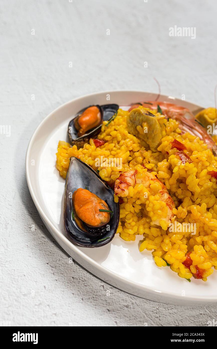 Traditional rice in paella with fish and meat. Typical Spanish Stock