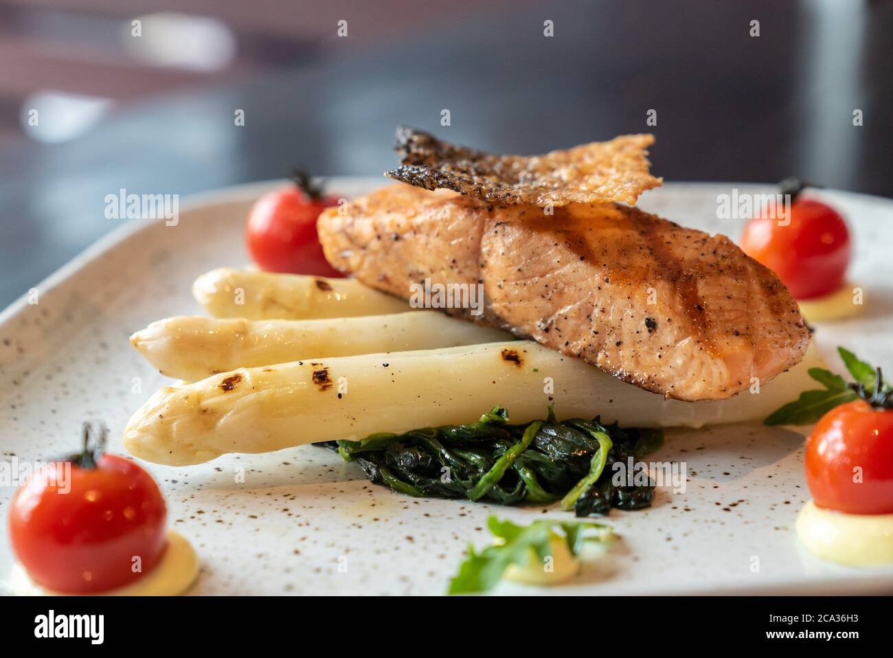 Grilled Salmon Fillet with grilled white asparagus serve with tomato ...